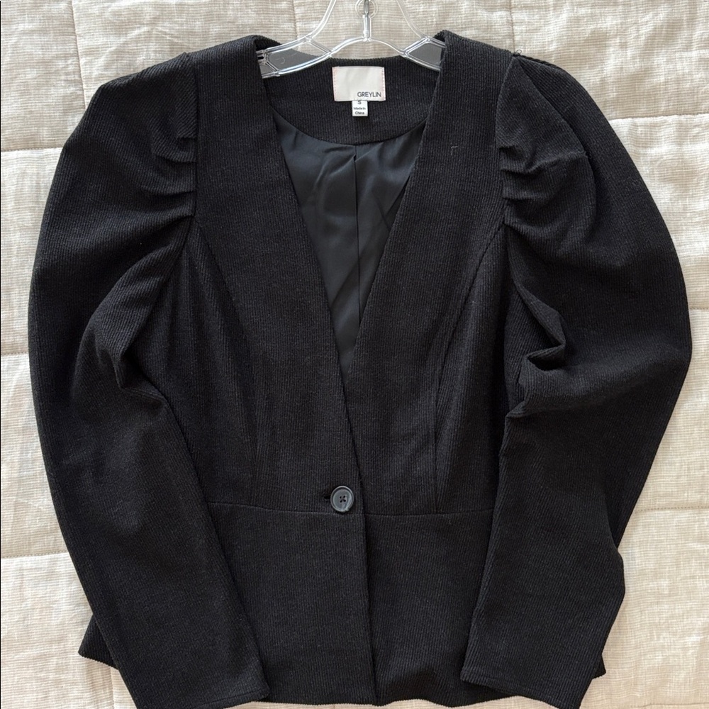 The jacket is soft and very comfortable. It is a dark grey almost black color.